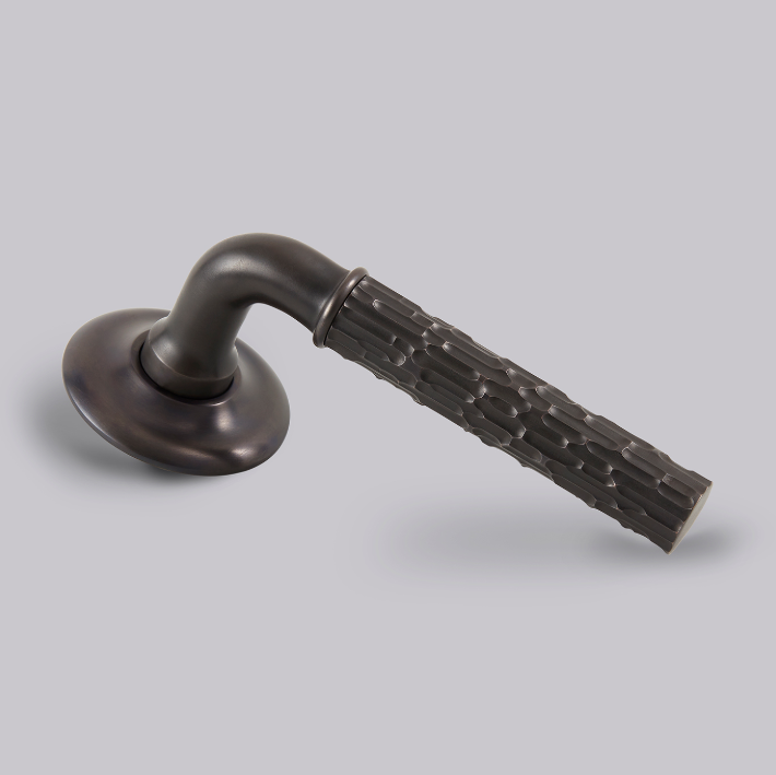 Featured image of Croft’s latest British-made hardware collection, highlighting a dark bronze door handle with a textured, patterned lever and round rose on a neutral background.