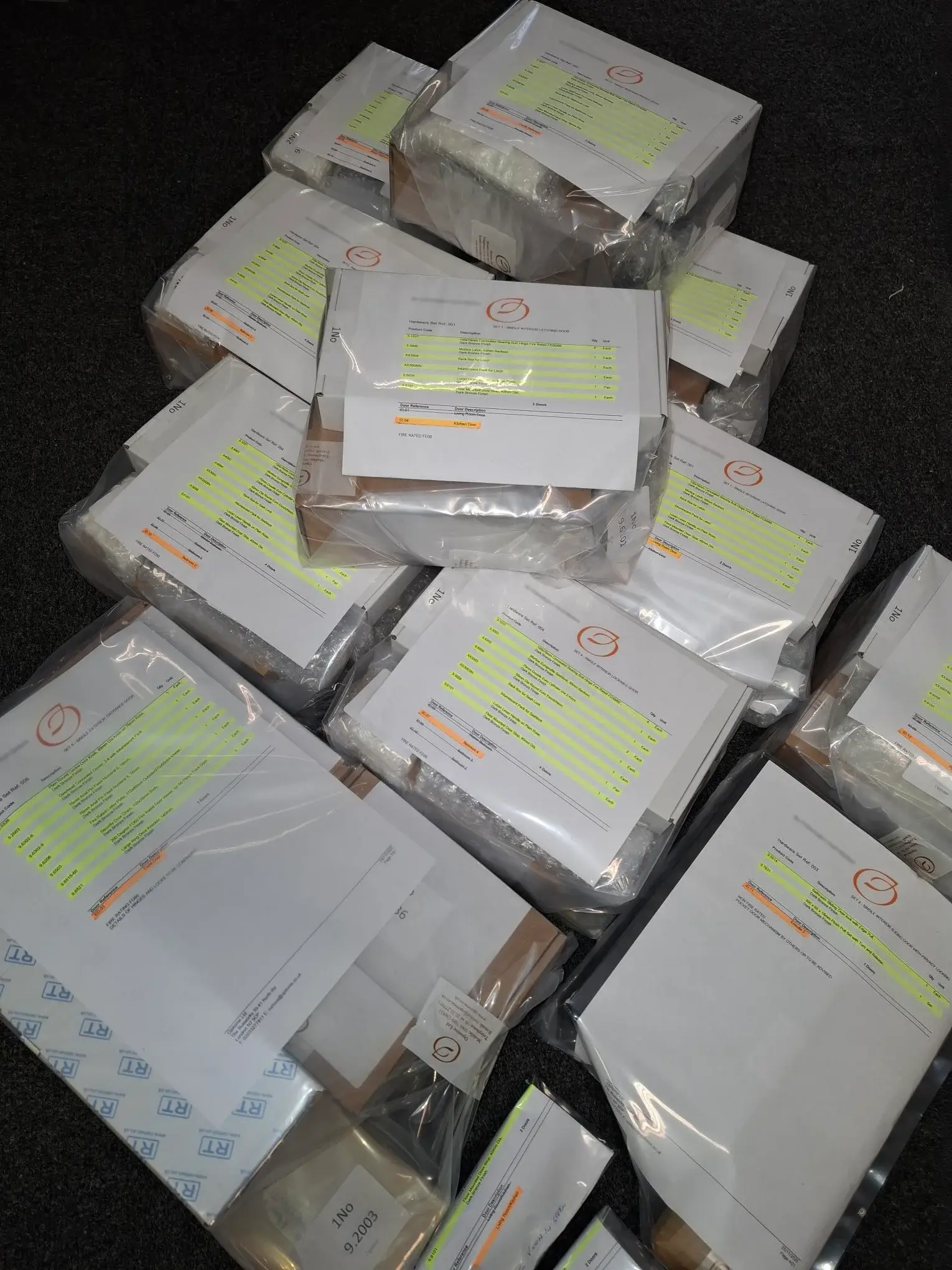 Door-by-door packed Opitome ironmongery sets prepared for organised architectural hardware installation.