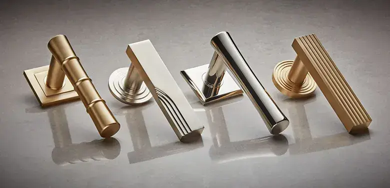 A selection of four luxury contemporary door levers in satin brass, polished chrome, and brushed nickel finishes chosen by a hardware concierge.