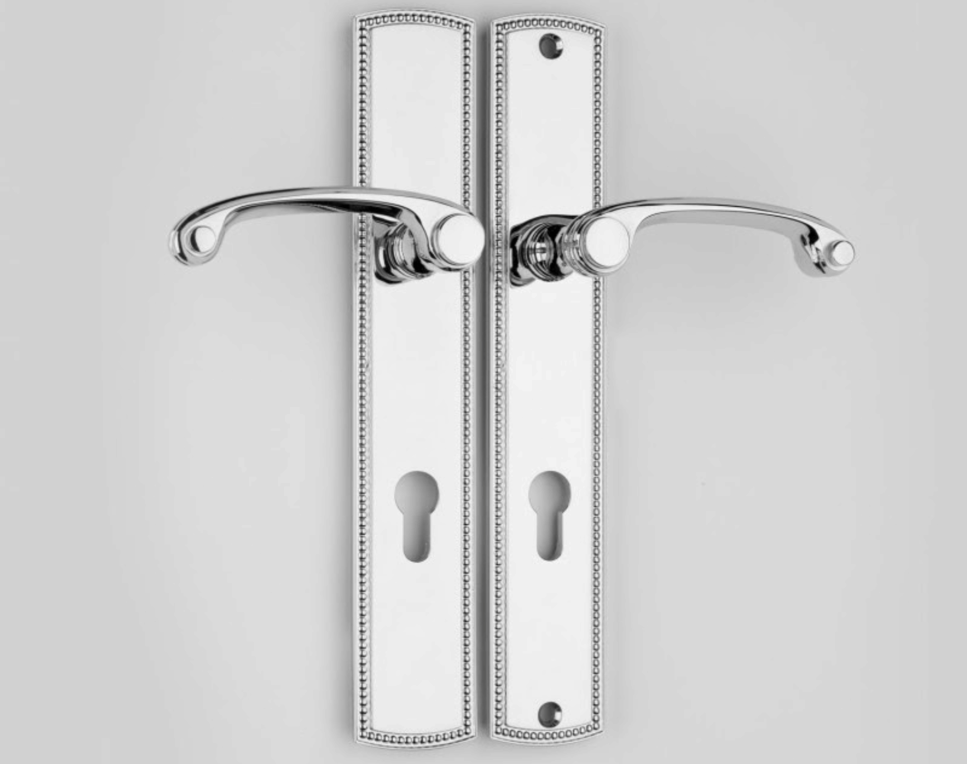 Silver door handles as an example of architectural ironmongery used on modern interior doors.
